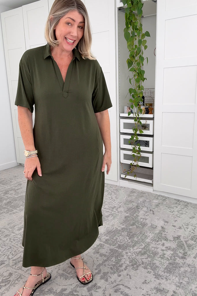 Model wearing a oversized, relaxed green dress with sandals.