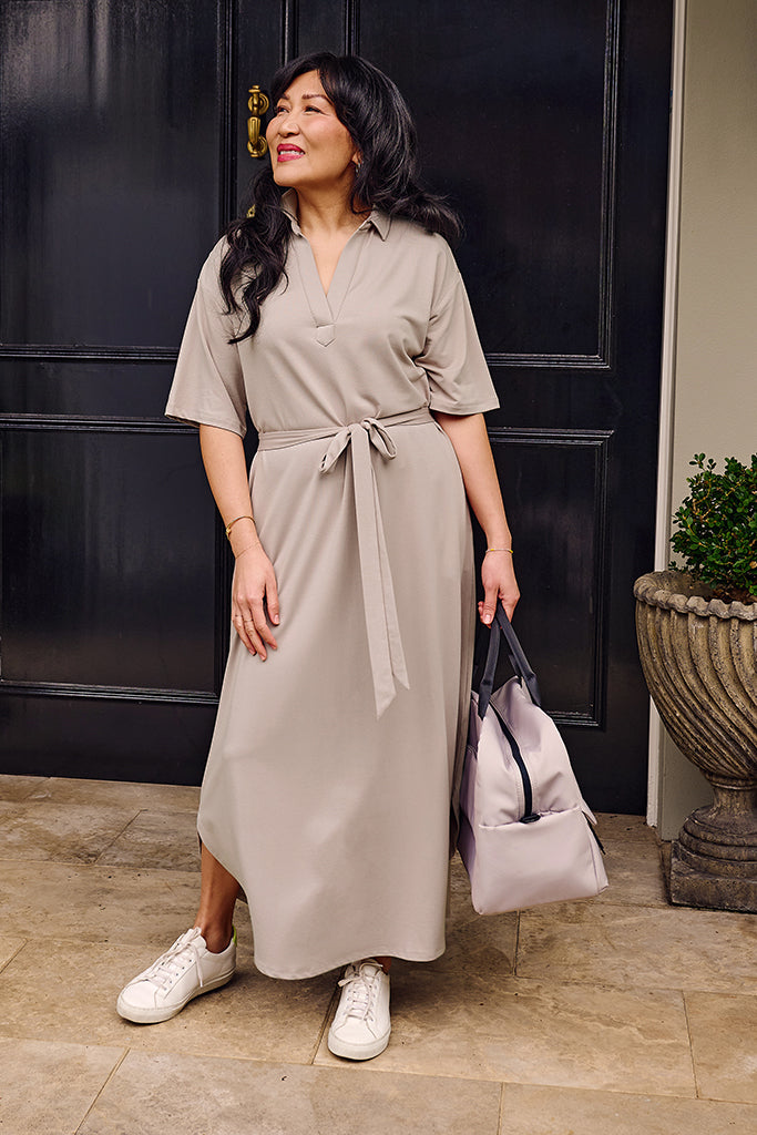 Model wearing a beige travel dress made out of a french terry bamboo blend.