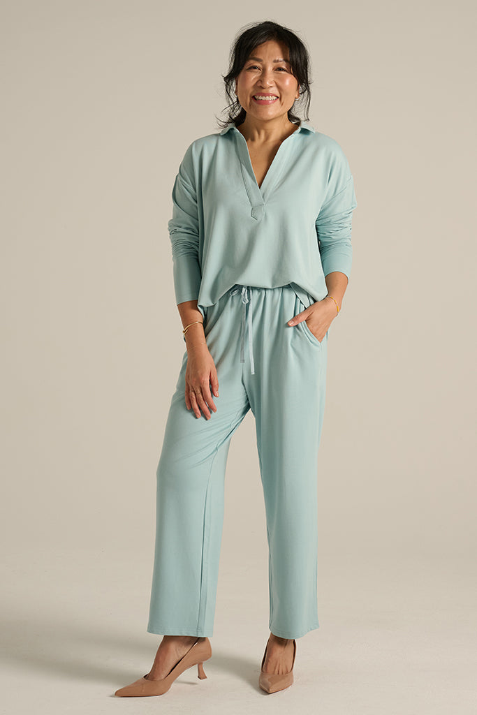 model wearing long pants with side pockets in aquamarine colour
