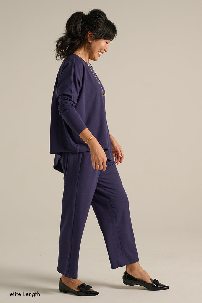 side view of the ankle length travel pants with side pockets in an indigo blue colourway