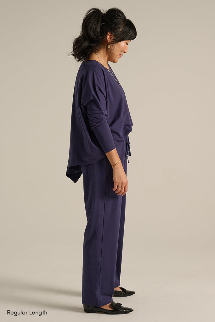 side view of the long travel pants in indigo blue
