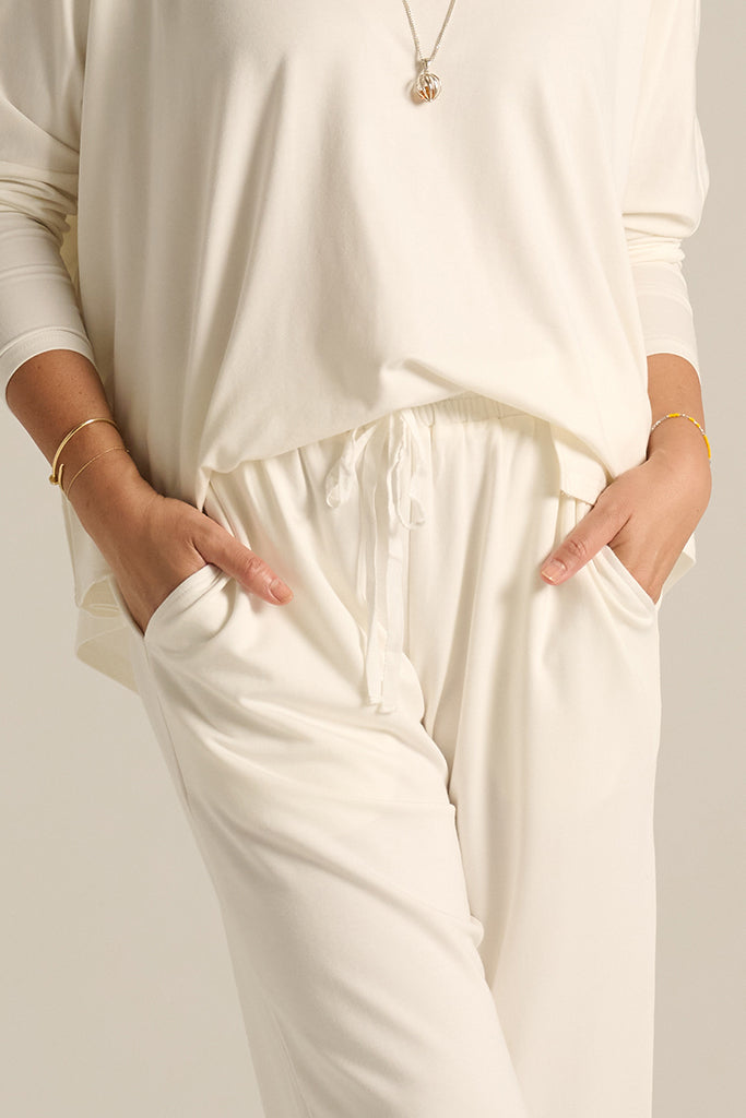 close up view of the Voyager pant in soft white with the side pockets and adjustable drawstring