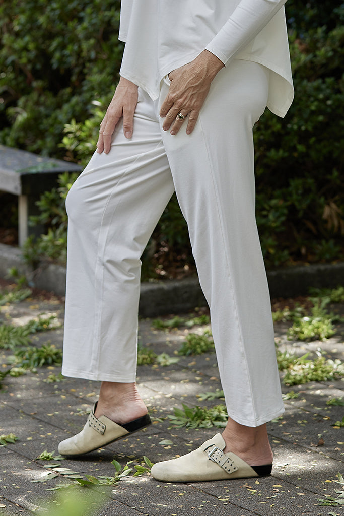 close up view of the Voyager pants in soft white colour with ankle-length cut