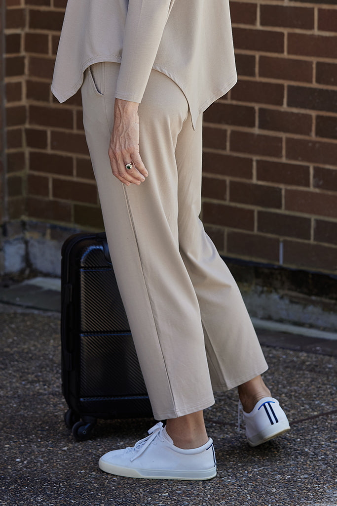 side view of the beige travel pants with the side pockets