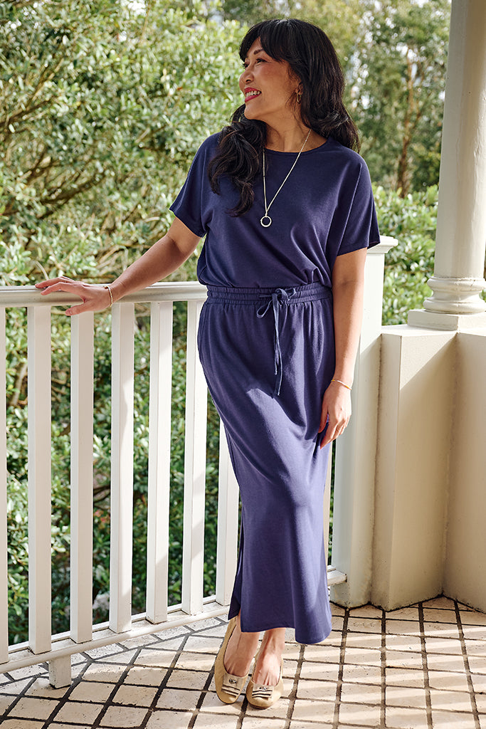 Front view of model wearing a comfortable and elevated purple bamboo set.