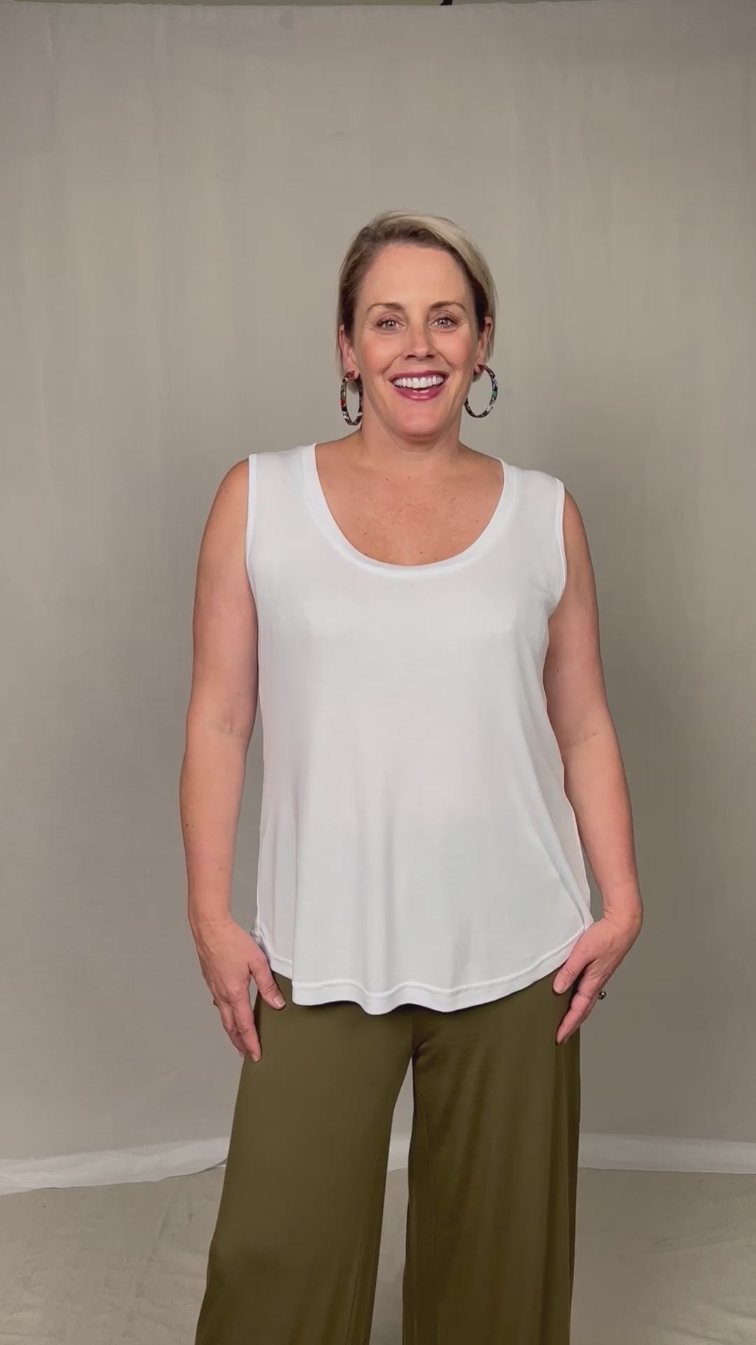 a model talking through her outfit featuring bamboo luxe wide leg pant and a relaxed white tank top