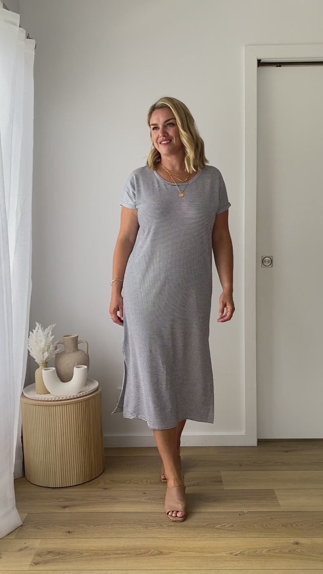 Video of a model posing in a oversized summer bamboo dress, featuring short sleeves and a round neckline