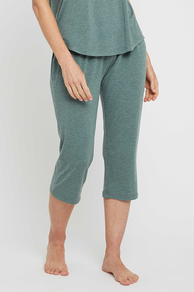 A person standing wearing Moss Green 3/4 length pants with an elasticated drawstring waist and straight leg.