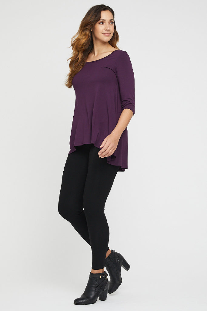 a tall model wearing black bamboo leggings in black paired with the plum hi lo top