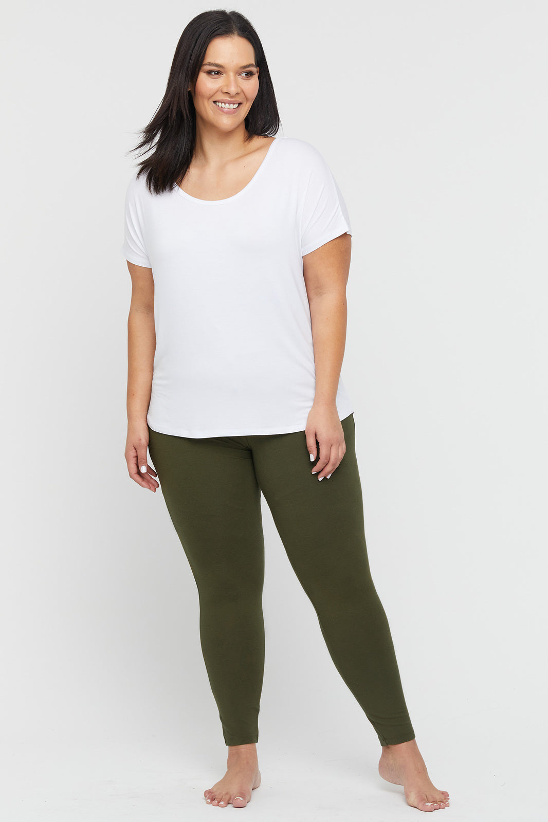 a plus size model wearing dark olive full length bamboo leggings