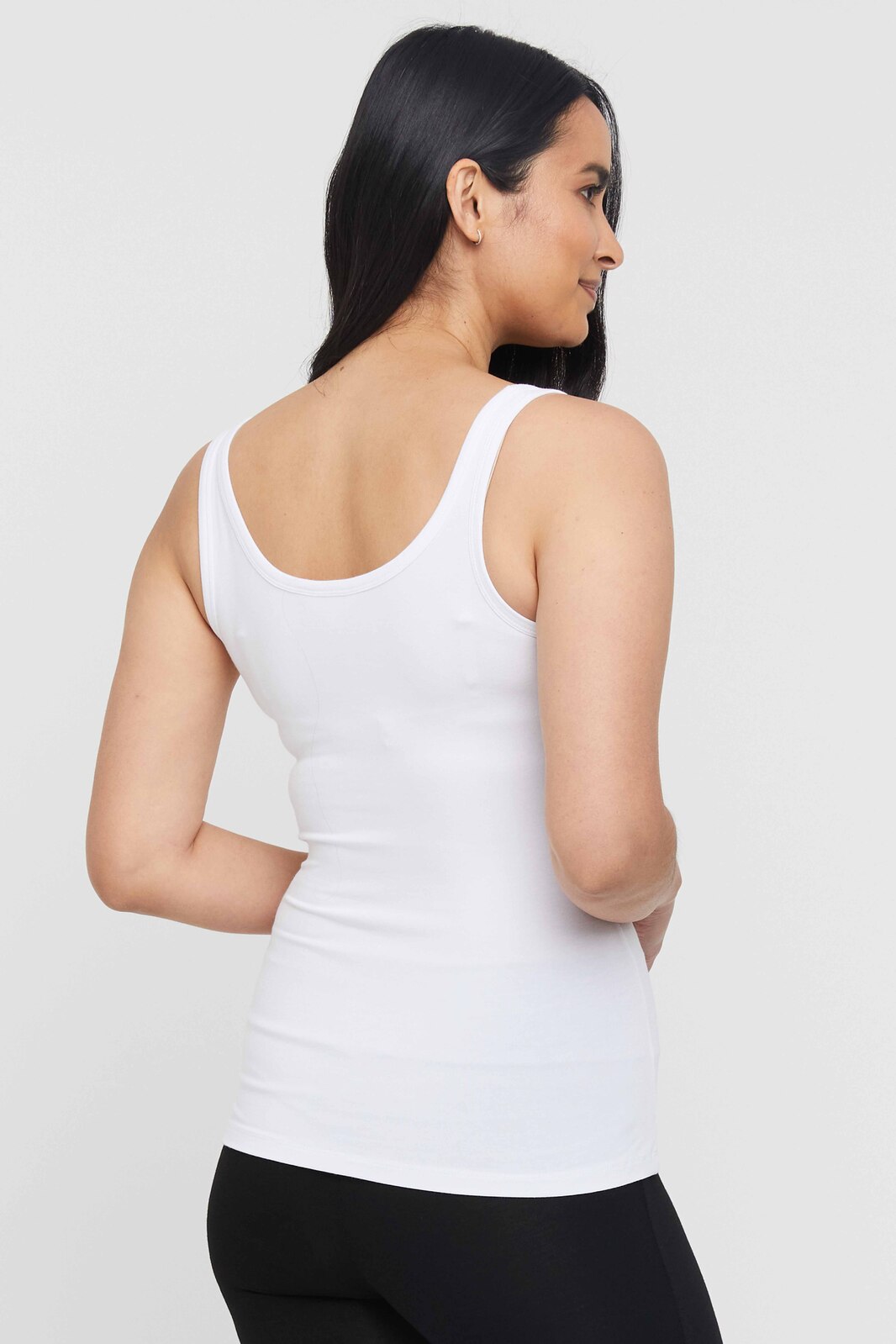 Back view of white scoop singlet with low neckline