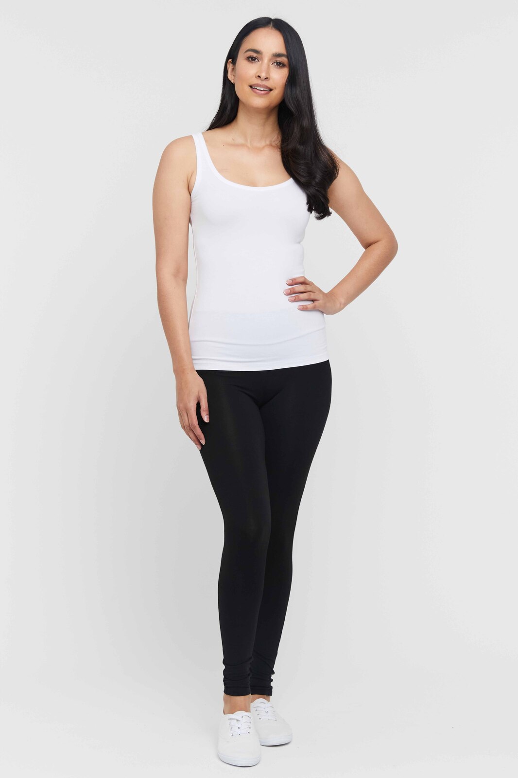 White sleeveless singlet with wide straps and figure hugging fit.