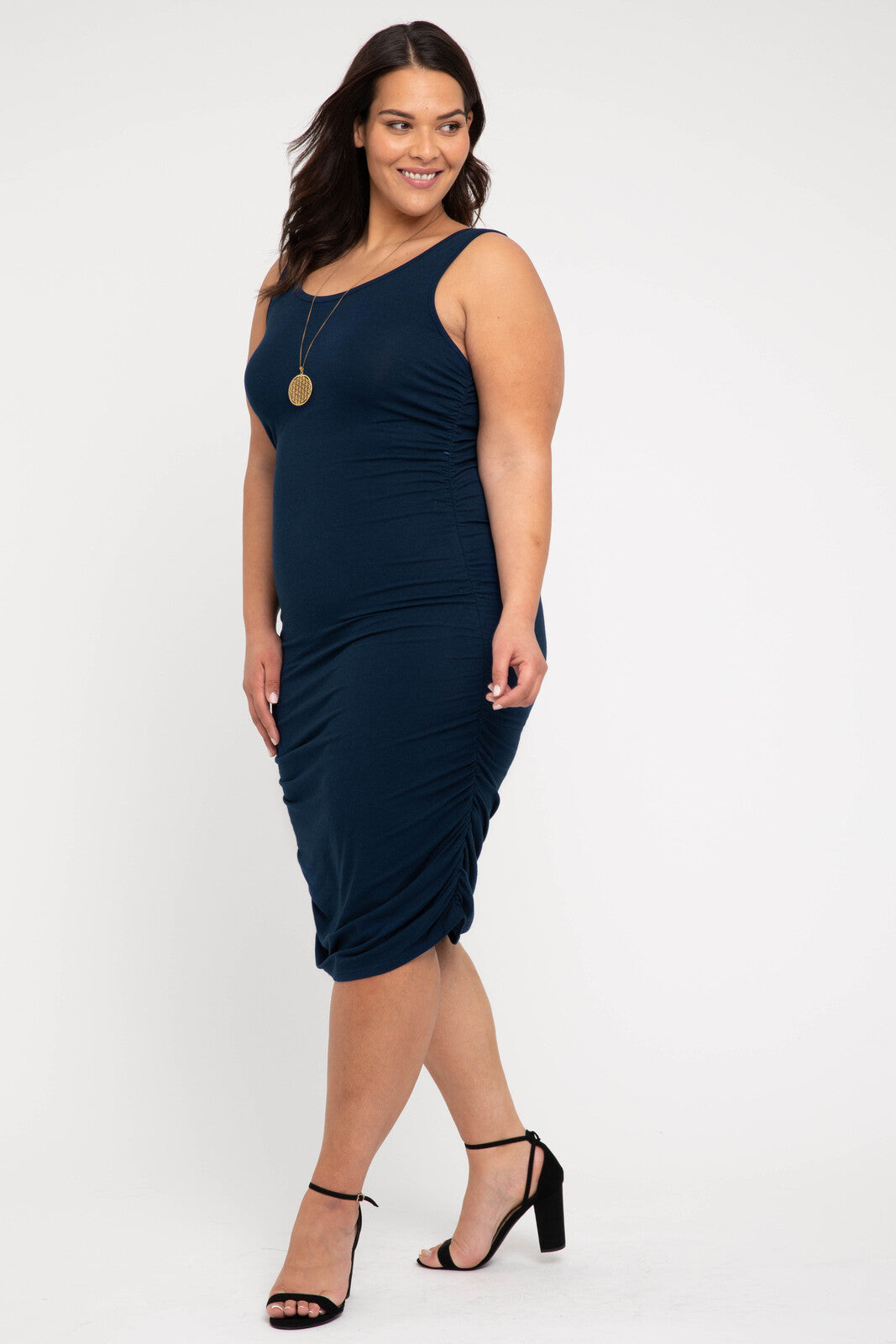 Side view of bamboo navy ruched tank dress emphasising figure-hugging silhouette and side gathering.
