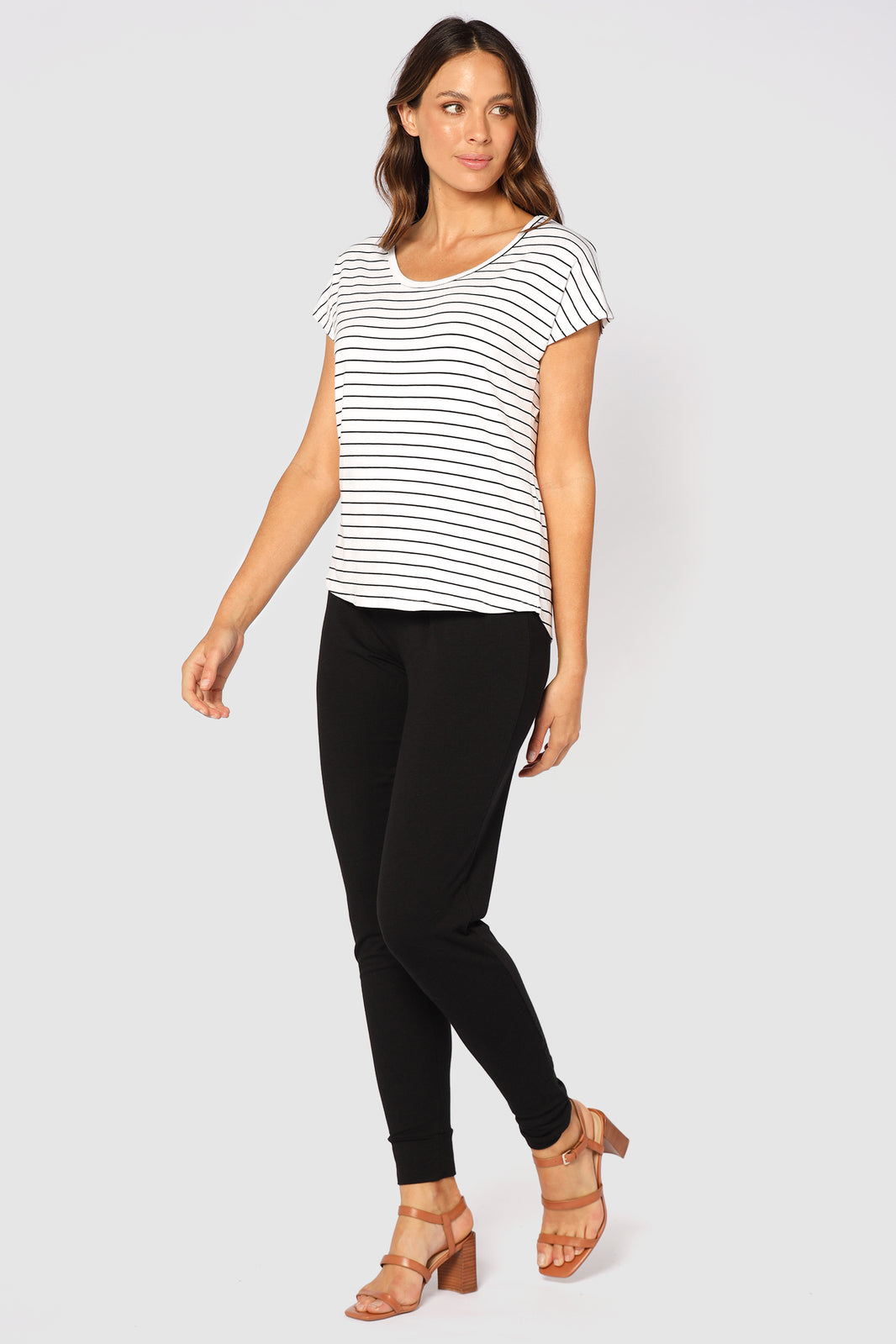 a model wearing full length slouch pants with cuffs on the ankles in bamboo fabric