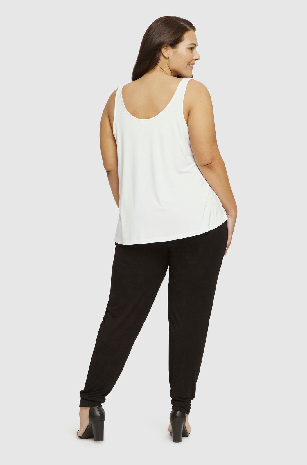 a back view of the bamboo slouch pants shown on a plus size model