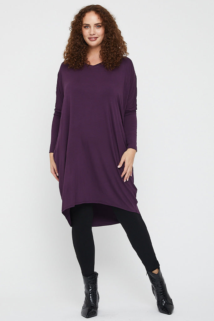 Loose and breathable plum dress with v neckline and long sleeves.
