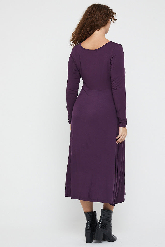 Back view of Olivia Dress with elegant long sleeves and flowing midi skirt.