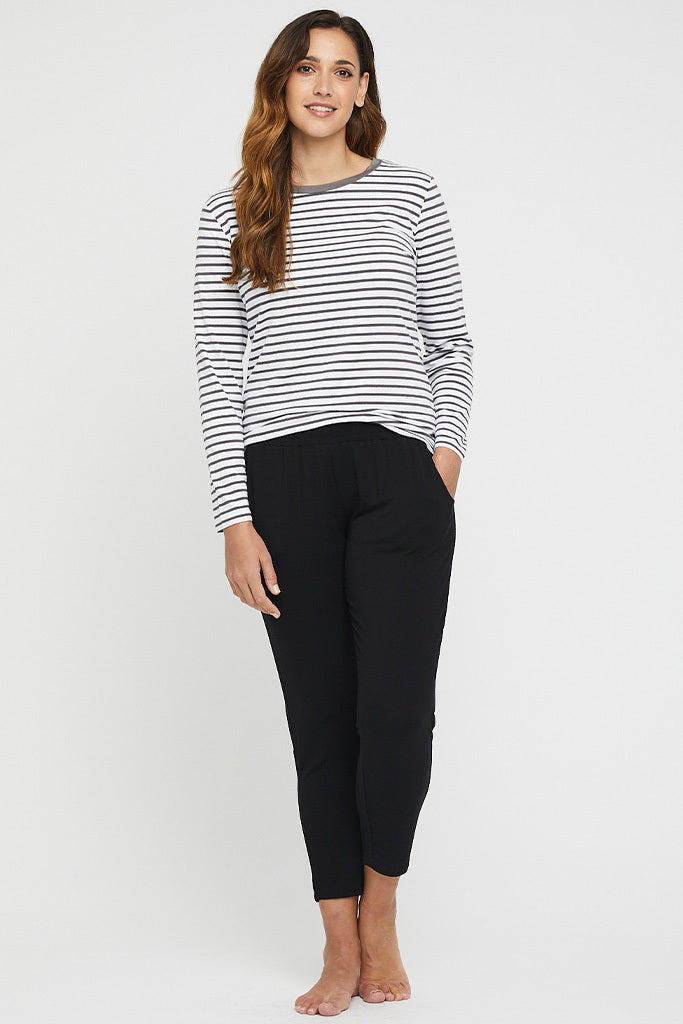 a tall plus size model wearing the Peggy bamboo trousers with side pockets styled with 3/4 sleeve stripe top and high heels