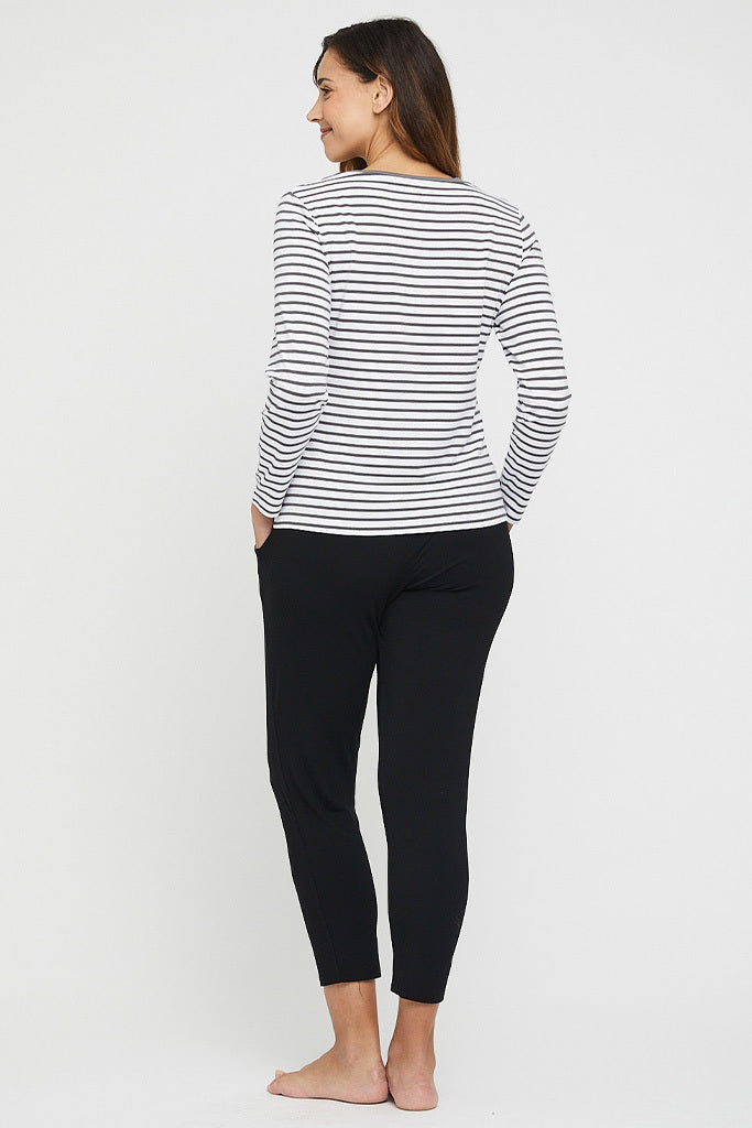 a back view of the peggy pants made of bamboo fabric with side pockets and a tapered leg