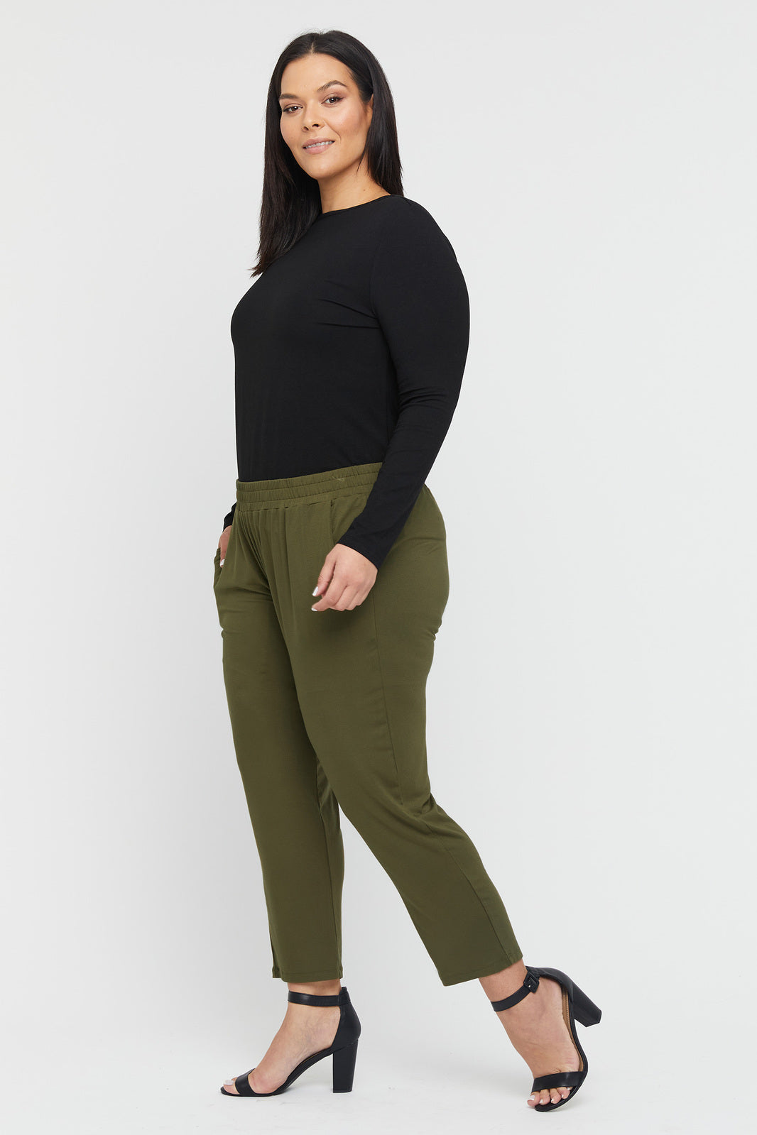 a plus size model wearing bamboo trousers in khaki colour with side pockets and an elastic band