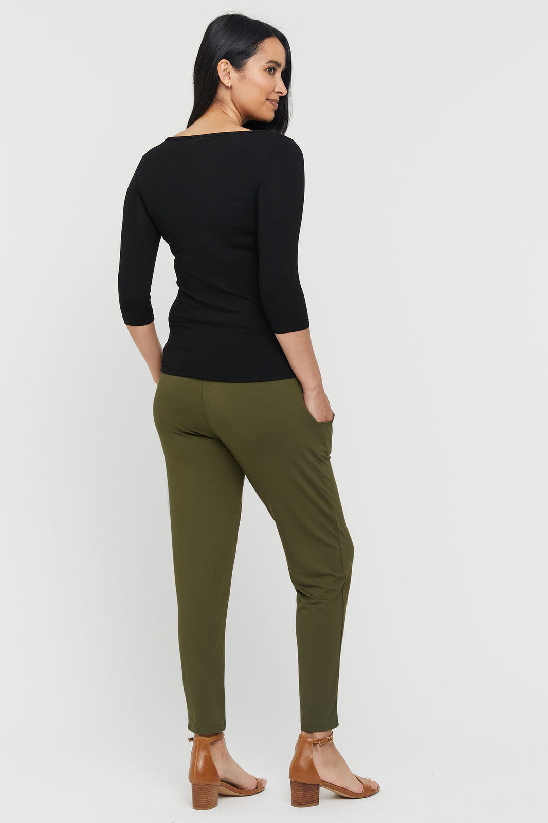 a back view of the peggy pants in dark olive with side pockets