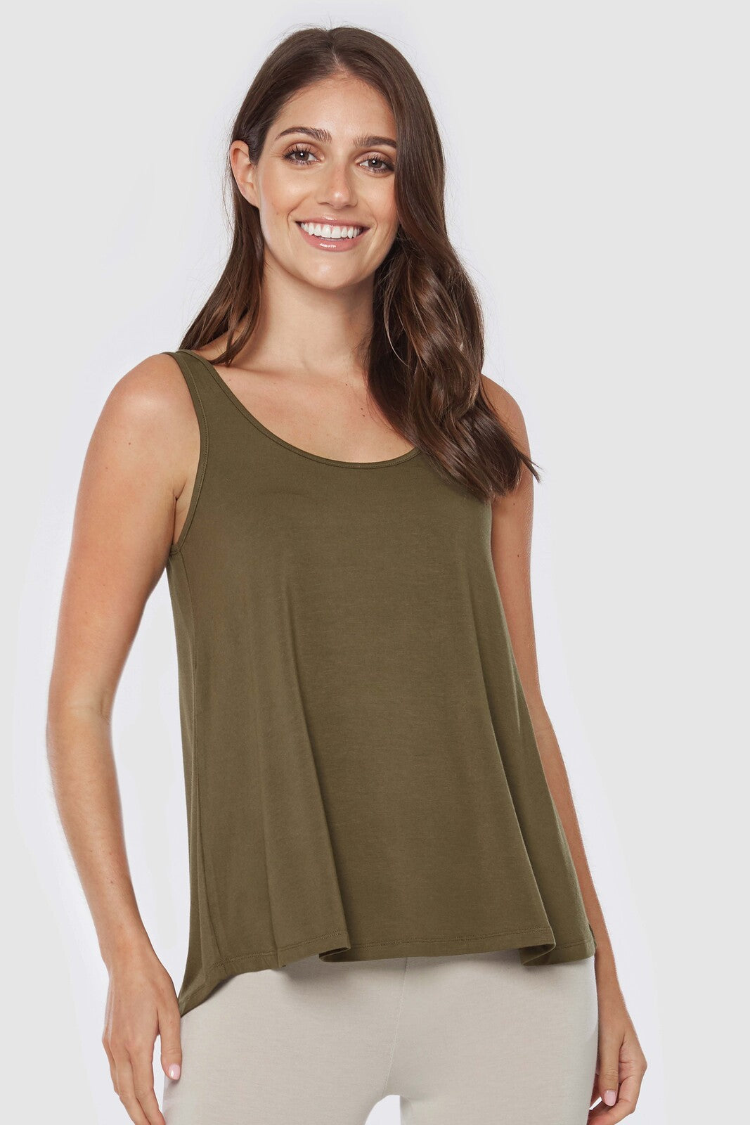 Model wearing dark olive relaxed fitted singlet with scoop neck line.
