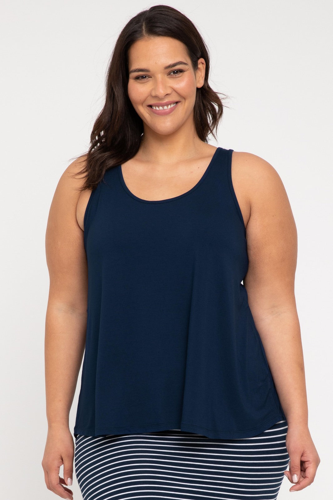 Plus size model dresses in navy blue singlet with curved neckline