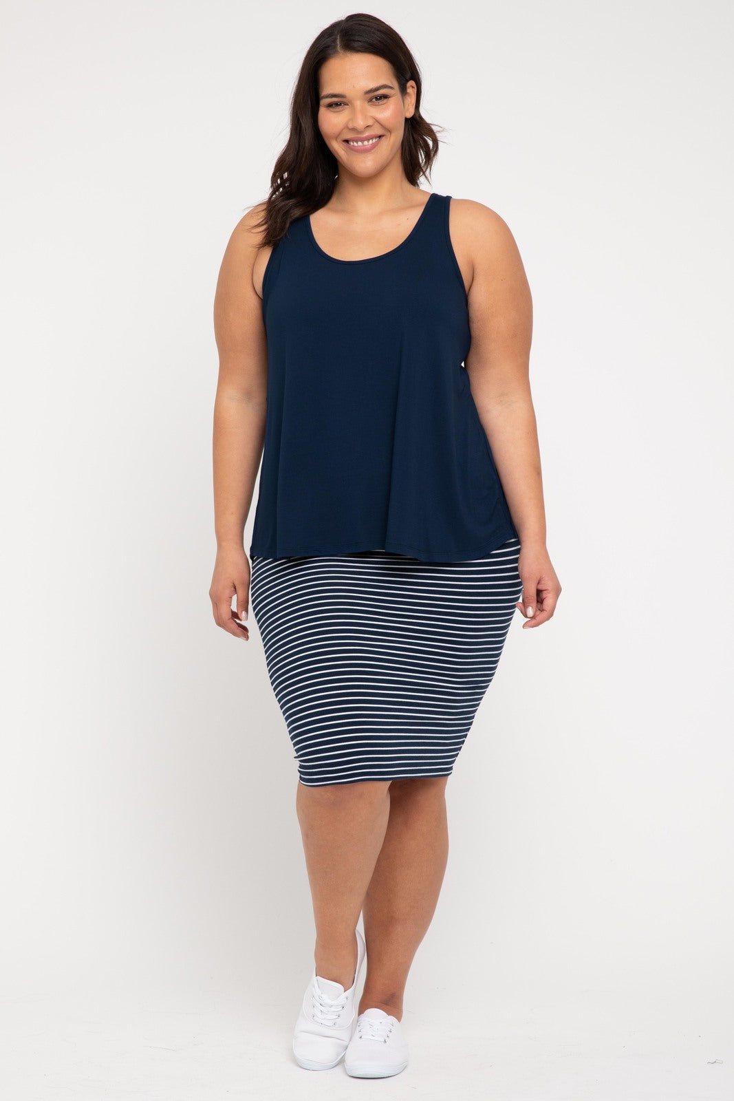 Curvy model in floaty feminine a-line navy shaded relaxed singlet.