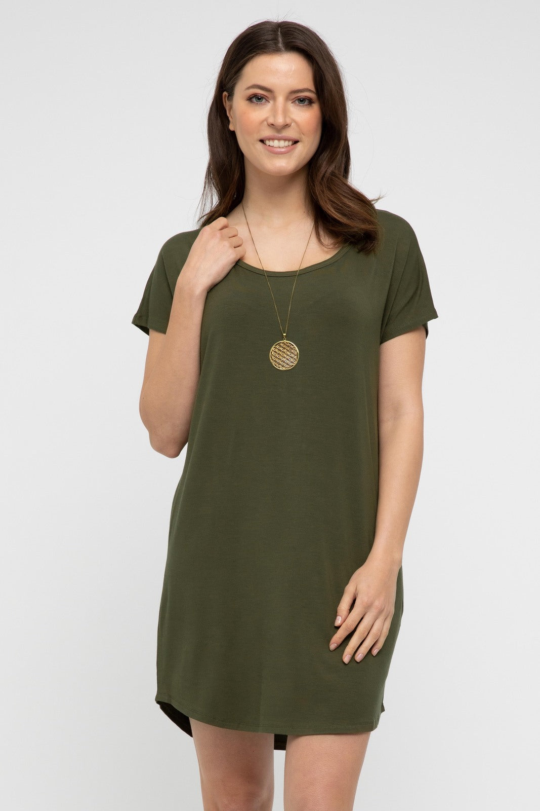 A woman wearing a dark olive, scoop neckline, short sleeve, above knee length dress. She is also wearing a necklace and the dress has a relaxed fit.