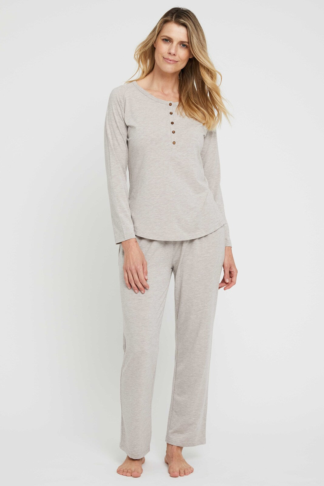 Model wearing beige pyjama pants featuring a straight leg and relaxed fit.