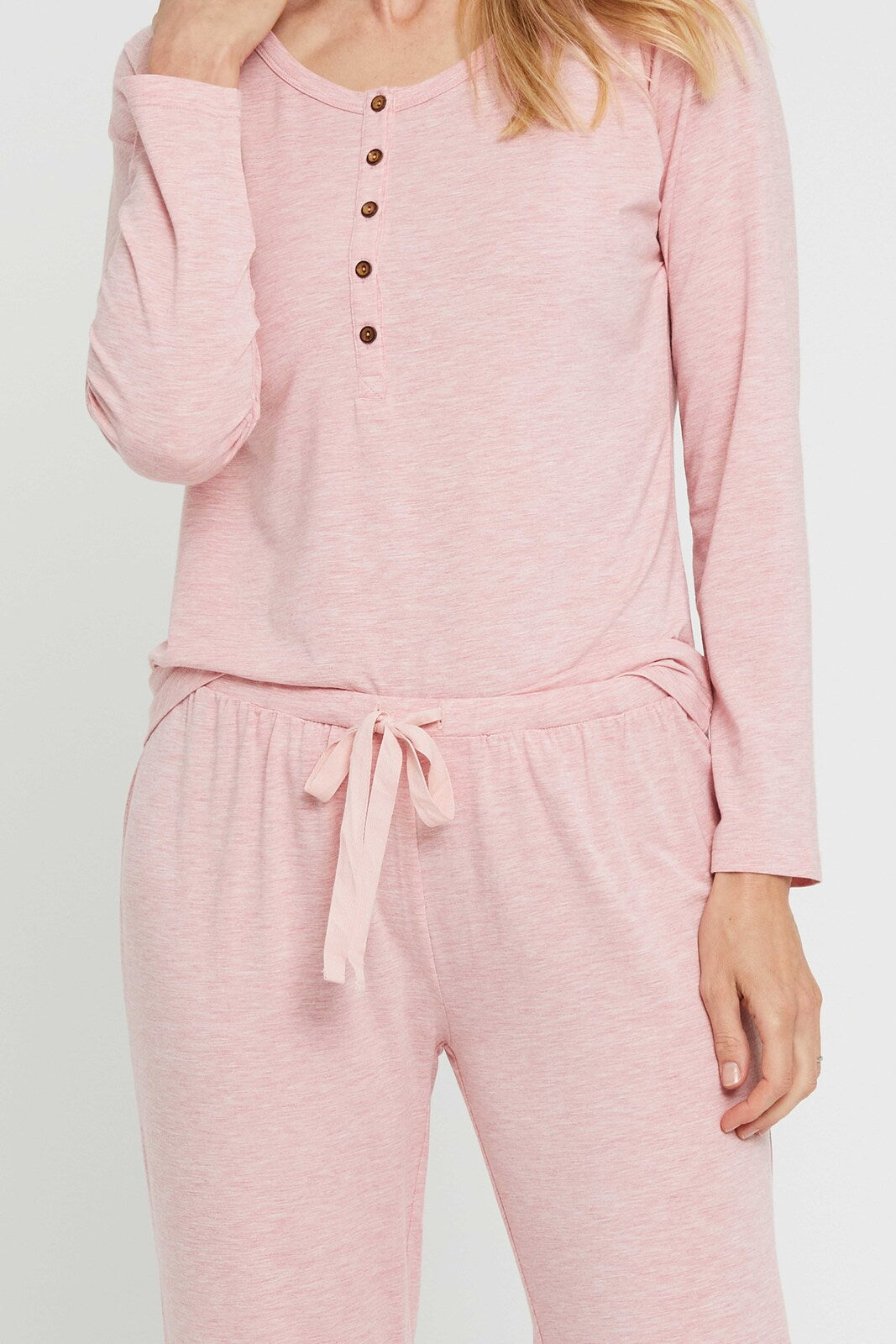 Closeup of pink bamboo pyjama pants, featuring comfortable drawstring waist.