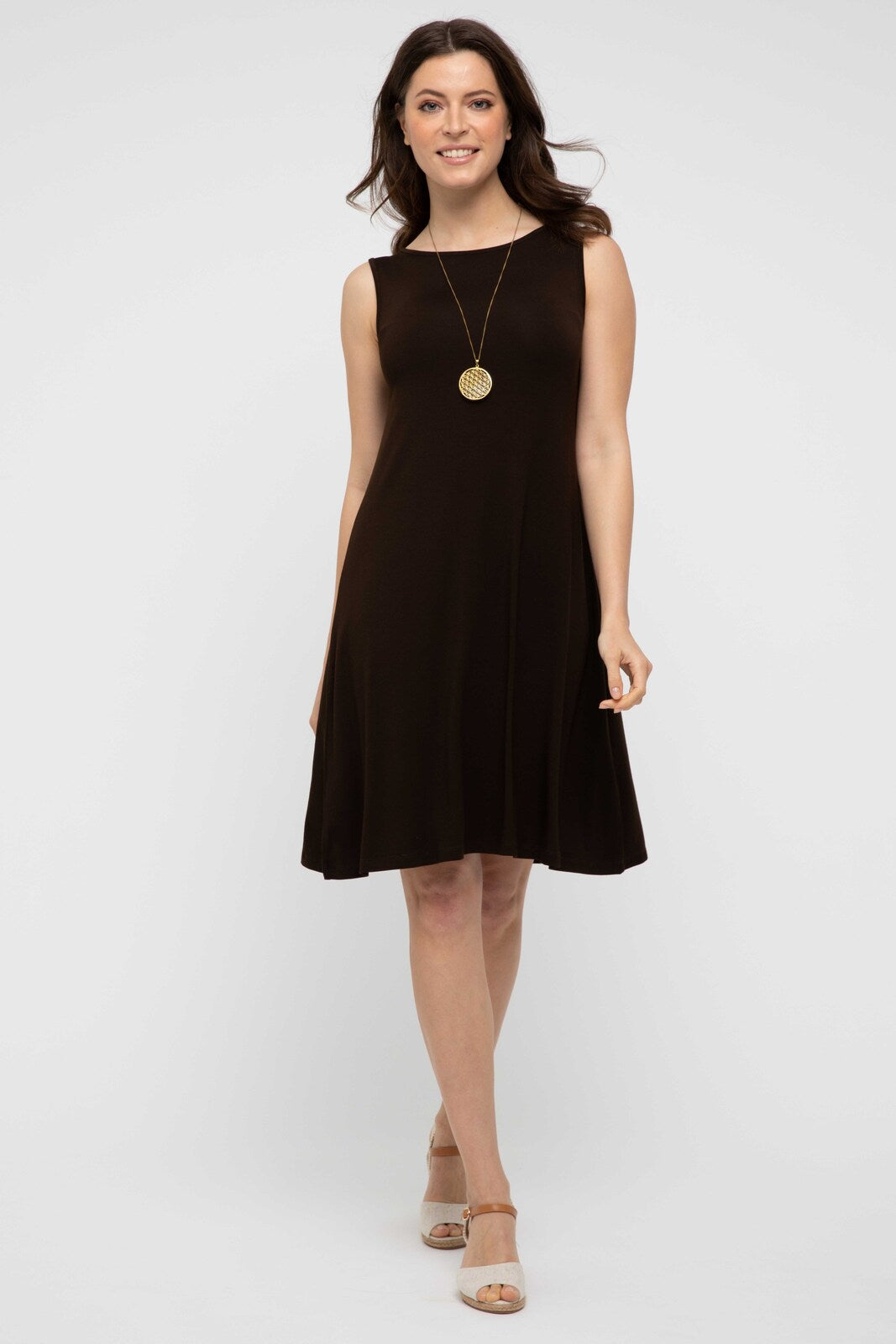 Woman wearing a brown mini dress with wedges.