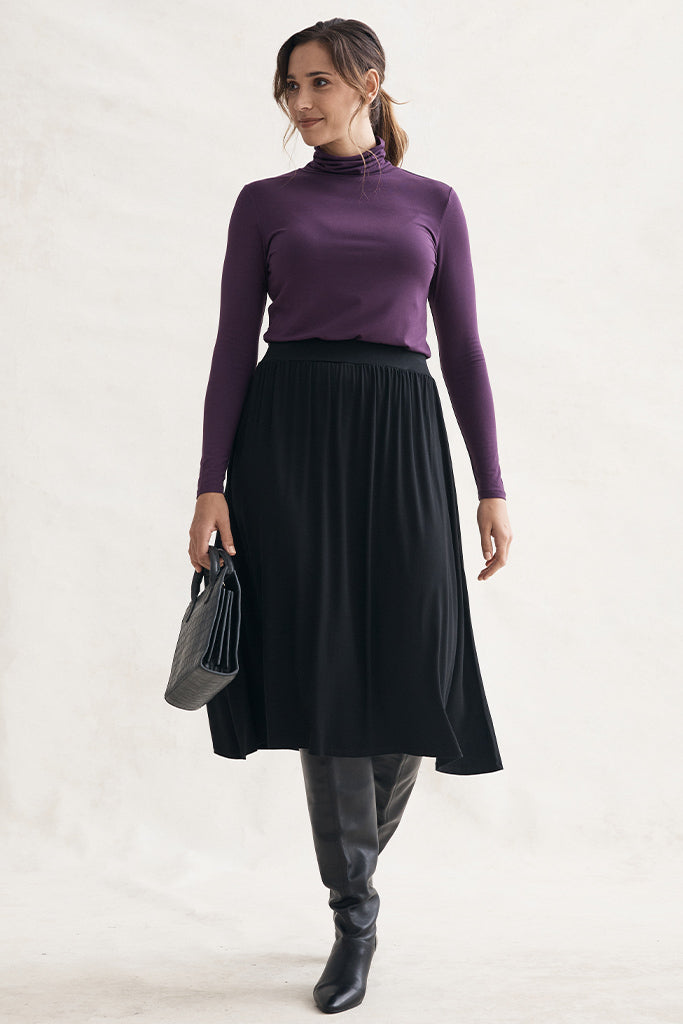 midi skirt styling for winter with boots and turtleneck