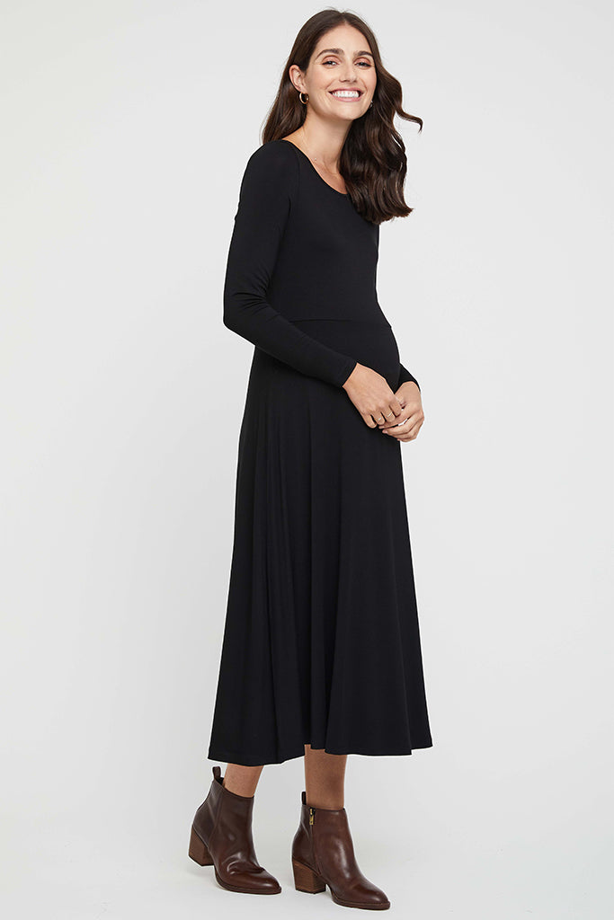 Side view of maternity Olivia Dress in black with fitted long sleeves and flowing skirt
