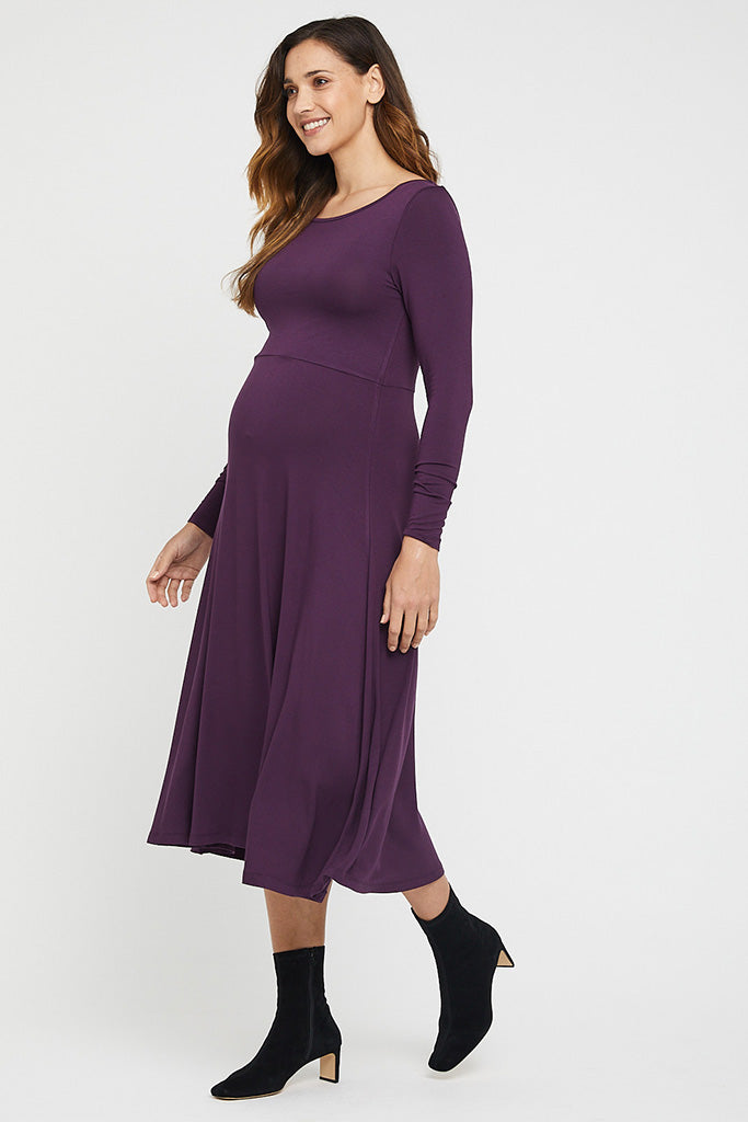 Side view of  long sleeve maternity dress in purple showing stretch over baby bump.