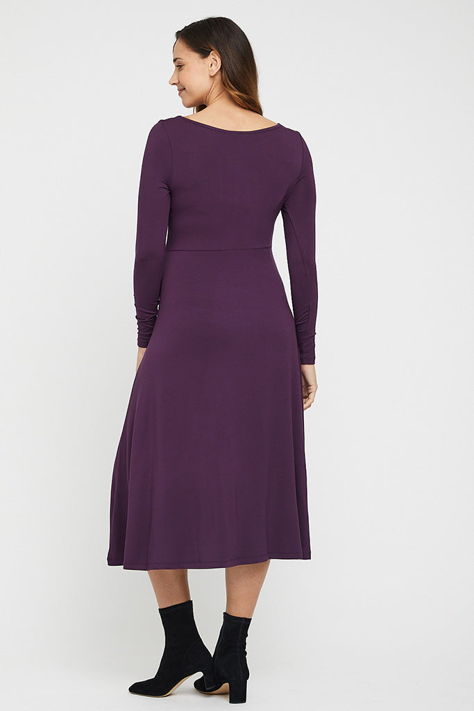 Maternity midi dress with long sleeves, designed to flatter and accomodate pregnancy curves.