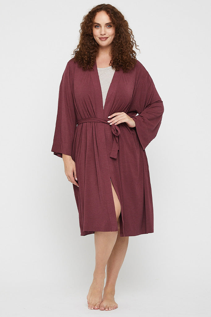 Plus size model wearing a burgundy sleepwear robe made out of soft bamboo