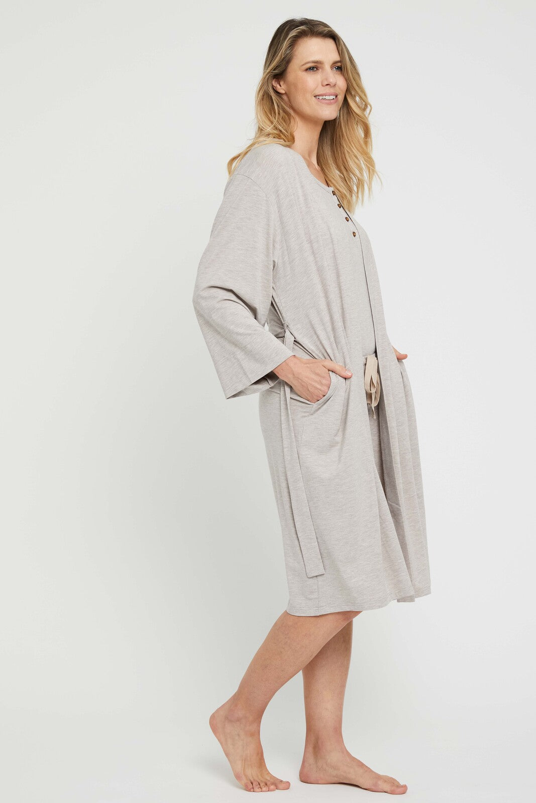 Side view of model wearing a beige bamboo sleepwear robe with side pockets