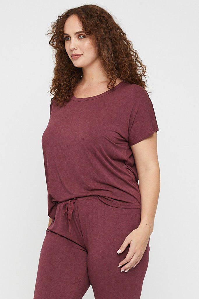 Side view of curvy burgundy lounge tee made out of hypoallergenic fabric.