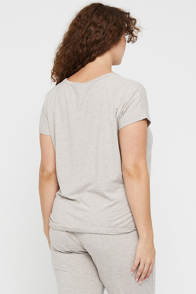 Back view of curvy model wearing a timeless beige pyjama tee for ultimate comfort.