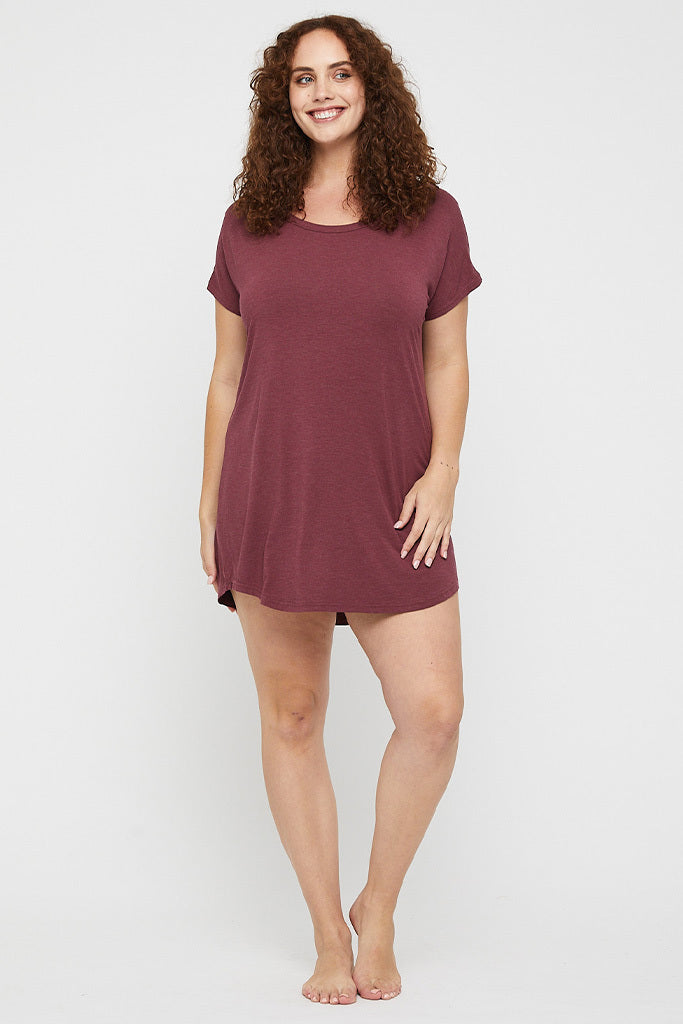 Plus size model wearing a soft and lightweight bamboo night dress in burgundy marle.