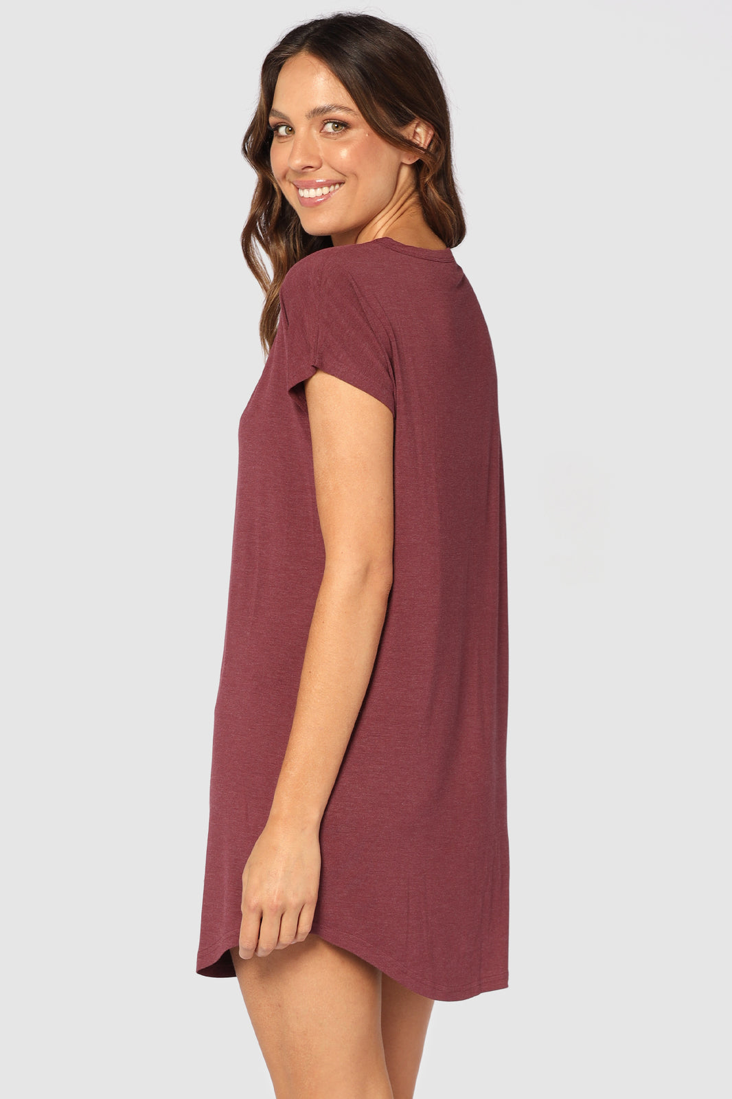 Back view of model wearing a bamboo night dress in burgundy, featuring short sleeves and an above-knee length