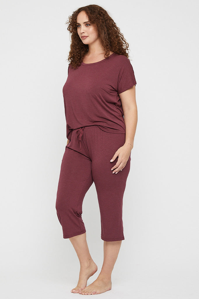 Side view of curvy model wearing 3/4 PJ pants, featuring a drawstring waist and elasticated waistband.