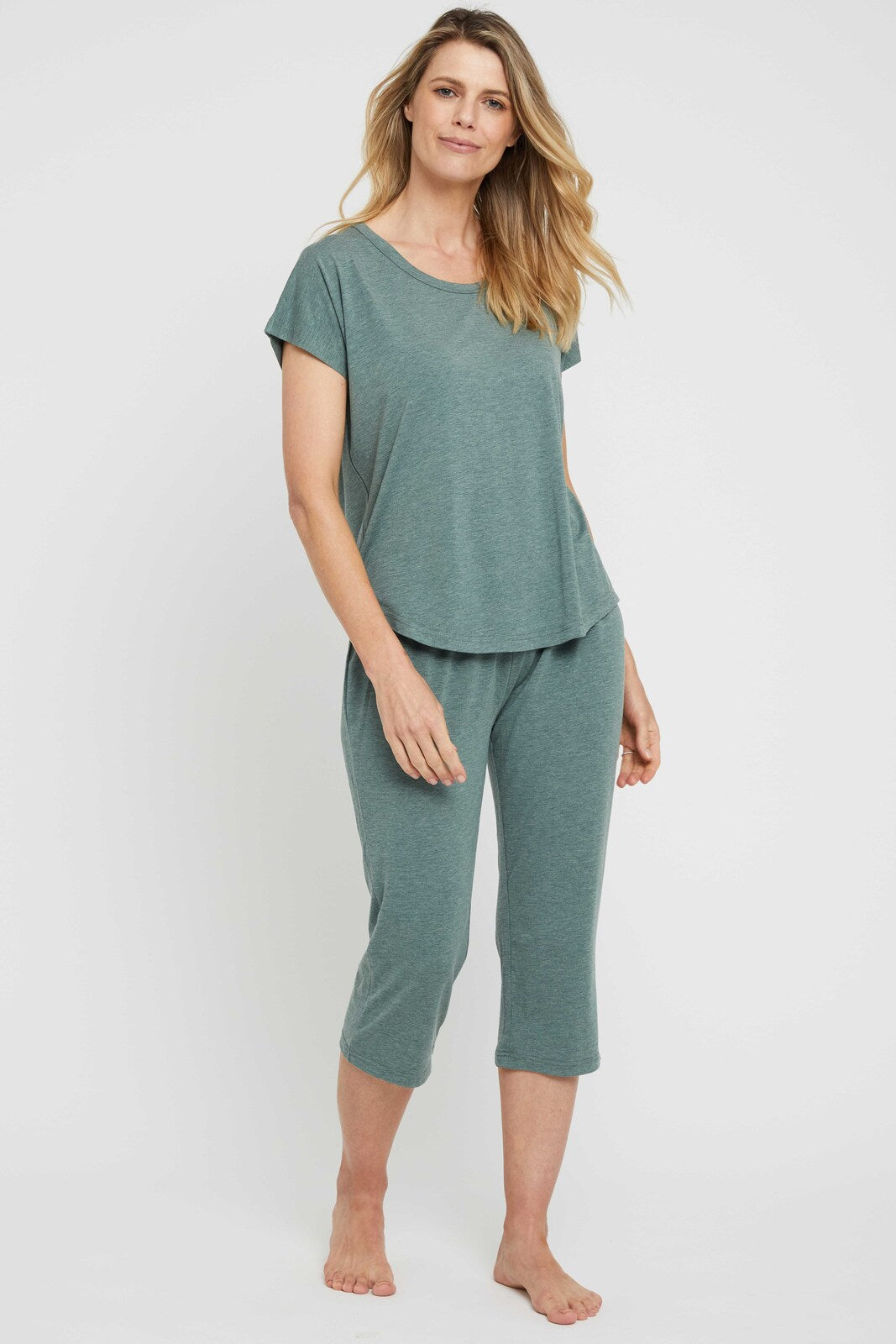 Model wearing breathable 3/4 pyjama pants in green paired with matching lounge tee