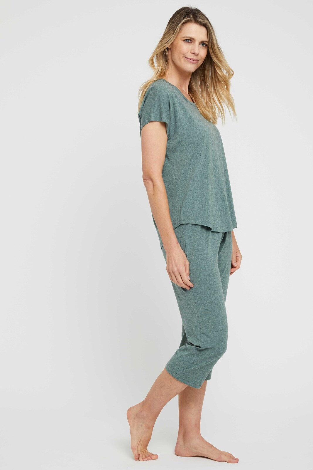 Side view of stretchy and lightweight 3/4 bamboo pyjama bottoms in green marle.