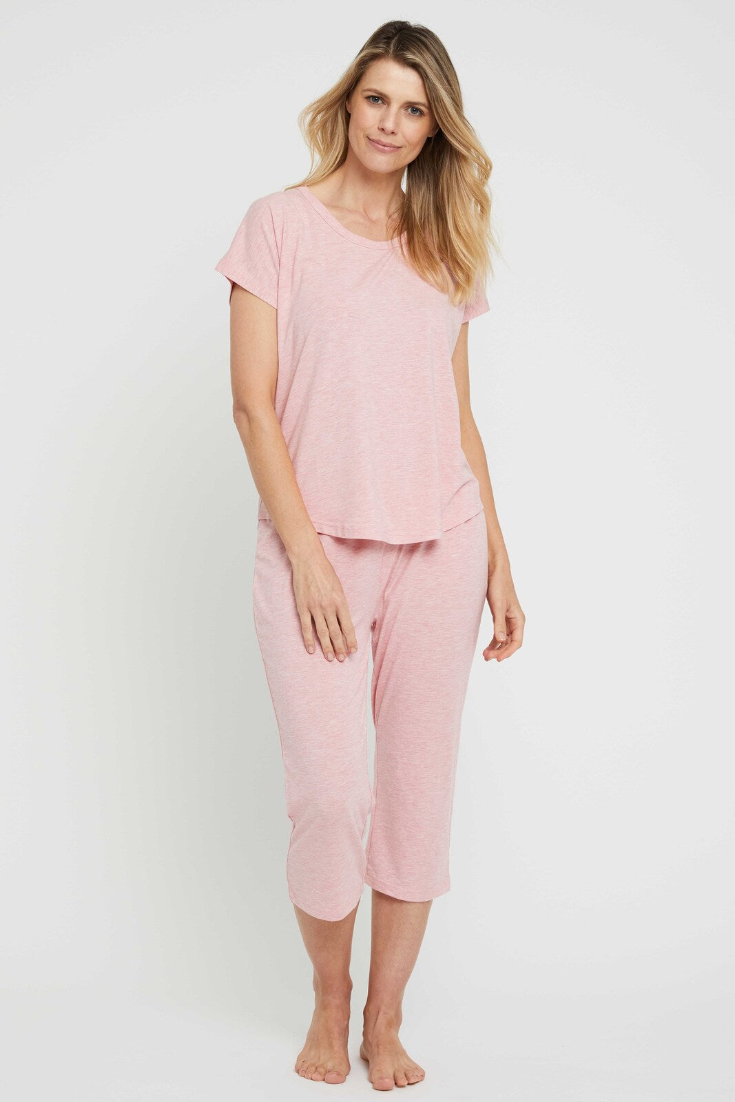 Model wearing soft 3/4 pink pyjama pants featuring a relaxed fit and straight leg.
