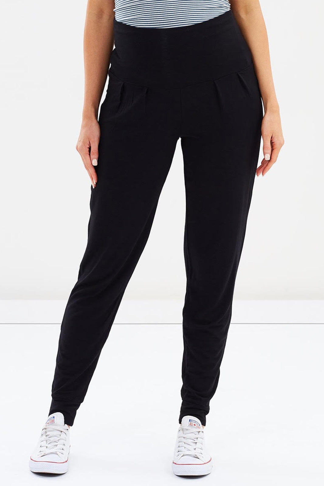 a close up view of bamboo slouch pants with cuffed ankles and a wide foldable waistband in black colour